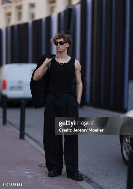 Bene Schulz is seen wearing a complete black look, black tanktop, black pants, black shades and black shoes and a black blazer and silver necklace...