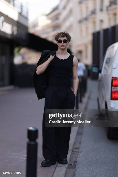 Bene Schulz is seen wearing a complete black look, black tanktop, black pants, black shades and black shoes and a black blazer and silver necklace...