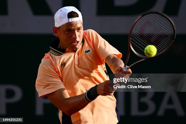 Filip Krajinovic of Serbia plays a backhand against Frances Tiafoe of United States during their Men's Singles First Round Match on Day Two of the...