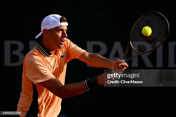 Filip Krajinovic of Serbia plays a backhand against Frances Tiafoe of United States during their Men's Singles First Round Match on Day Two of the...