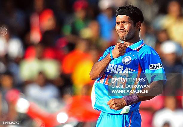 Indian cricketer Ashok Dinda celebrates after dismissing Sri Lankan cricketer Kumar Sangakkara during the third one day international match between...