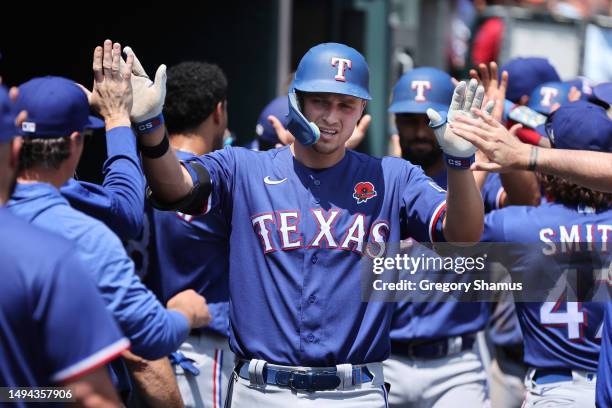 Corey Seager of the Texas Rangers celebrates his fifth inning three run home run with teammates while playing the Detroit Tigers at Comerica Park on...