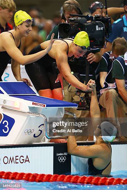 Brittany Elmslie, Emily Seebohm and Libby Trickett of Australia celebrate after they finished first in heat two of the Women's 4x100m Freestyle Relay...