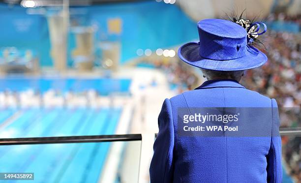 Queen Elizabeth II watches the morning session of the swimming at the Aquatics Centre during a tour of the Olympic Park on day one of the London 2012...