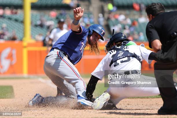 Travis Jankowski of the Texas Rangers is tagged out trying to score by Eric Haase of the Detroit Tigers in the seventh inning at Comerica Park on May...