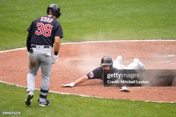 Myles Straw of the Cleveland Guardians slides safely into home on a Cam Gallagher of the Cleveland Guardians single in the seventh inning against the...