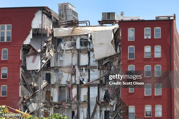 Debris hangs from a six-story apartment building after yesterday's collapse on May 29, 2023 in Davenport, Iowa. Eight people were rescued from the...