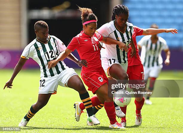 Desiree Scott of Canada and Andisiwe Mgcoyi of South Africa contest for the ball during the Women's Football first round Group F Match of the London...