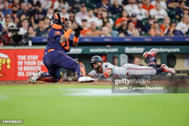 Willi Castro of the Minnesota Twins beats the tag from Martin Maldonado of the Houston Astros during the fourth inning at Minute Maid Park on May 29,...
