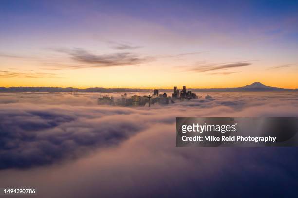 seattle on the clouds at sunrise - seattle sunset stock pictures, royalty-free photos & images