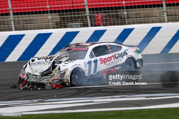Denny Hamlin, driver of the Sport Clips Haircuts Toyota, spins after an on-track incident during the NASCAR Cup Series Coca-Cola 600 at Charlotte...