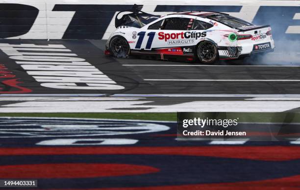 Denny Hamlin, driver of the Sport Clips Haircuts Toyota, spins after an on-track incident during the NASCAR Cup Series Coca-Cola 600 at Charlotte...