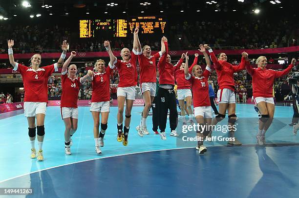 Denmark celebrate winning 21-18 in the Women's Handball preliminaries Group B - Match 4 between Denmark and Sweden on Day 1 of the London 2012...