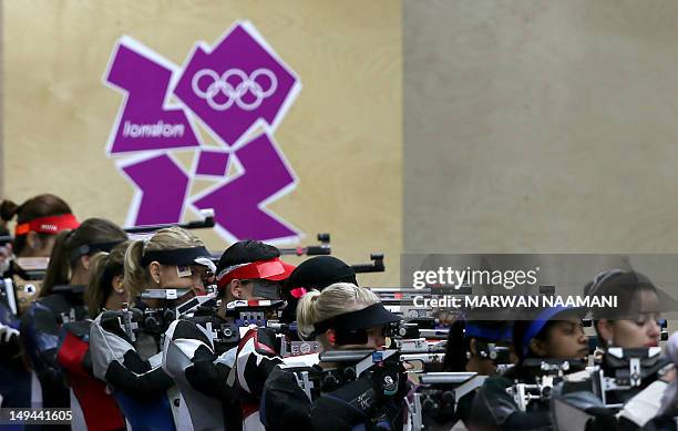 Shooters compete during the 10m Air Rifle women's qualification at the Royal Artillery Barracks in London on July 28 during the London 2012 Olympic...