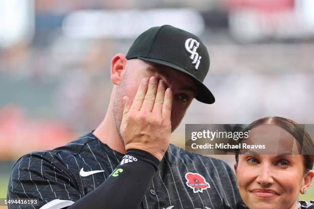 Liam Hendriks of the Chicago White Sox reacts as he is acknowledged with his wife, Kristi Hendriks, prior to the game against the Los Angeles Angels...