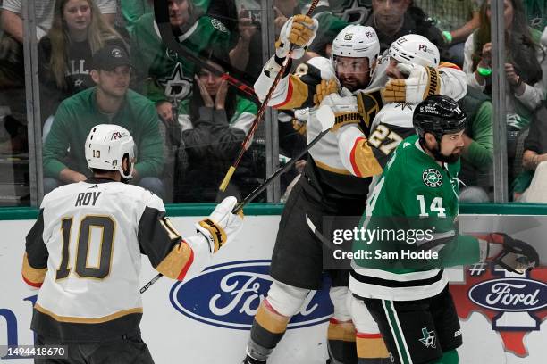 William Carrier of the Vegas Golden Knights celebrates with Shea Theodore after scoring a goal against the Dallas Stars during the first period in...