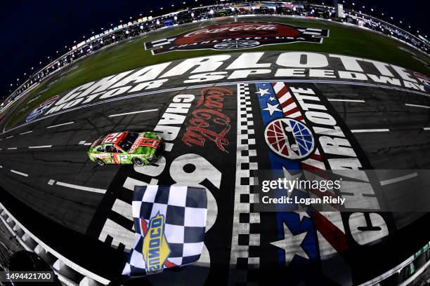 Ryan Blaney, driver of the BodyArmor Cherry Lime Ford, takes the checkered flag to win the NASCAR Cup Series Coca-Cola 600 at Charlotte Motor...