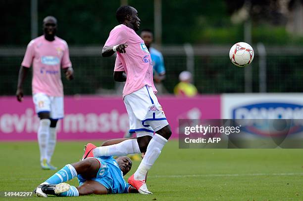 Evian's midfielder of Ghana Mohammed Rabiu is tackled by Marseille's Senegalese forward Andre Ayew during the friendly football match Evian Thonon...