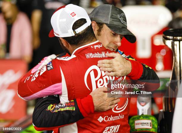 Ryan Blaney, driver of the BodyArmor Cherry Lime Ford, is congratulated by Bubba Wallace, driver of the Dr Pepper Strawberries & Cream Toyota, in...