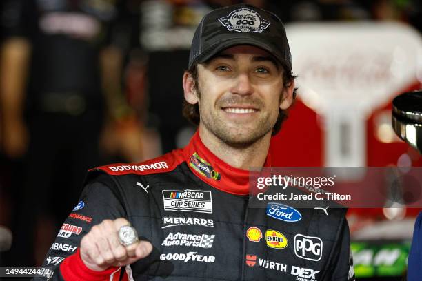 Ryan Blaney, driver of the BodyArmor Cherry Lime Ford, displays his Coca-Cola 600 ring in victory lane after winning the NASCAR Cup Series Coca-Cola...