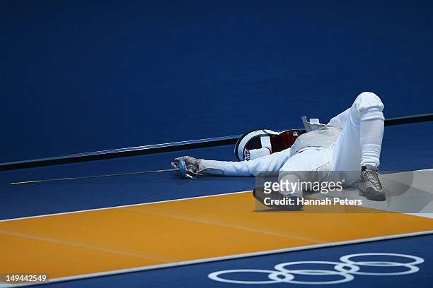 Carolin Golubytskyi of Germany lies on the ground after being struck in her Women's Foil Individual Fencing round of 16 match against Elisa Di...