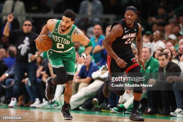 Jayson Tatum of the Boston Celtics dribbles against Jimmy Butler of the Miami Heat during the second quarter in game seven of the Eastern Conference...
