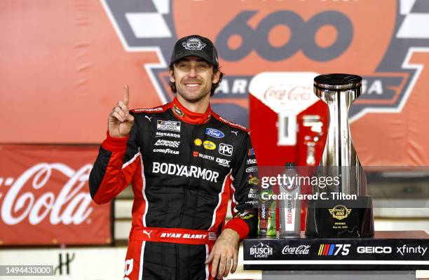 Ryan Blaney, driver of the BodyArmor Cherry Lime Ford, celebrates in victory lane after winning the NASCAR Cup Series Coca-Cola 600 at Charlotte...