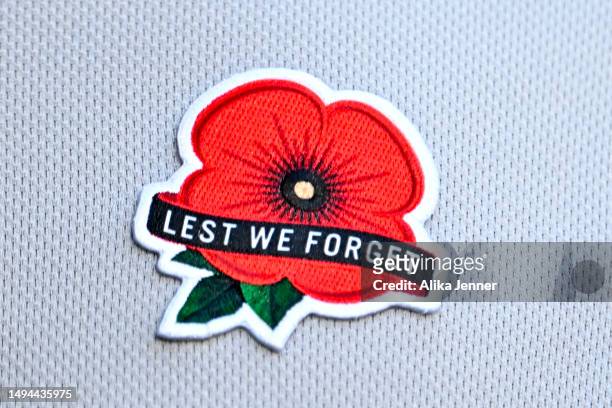 LeMahieu of the New York Yankees wears a traditional Memorial red poppy on the left side of his jersey with “Lest We Forget” language during the game...
