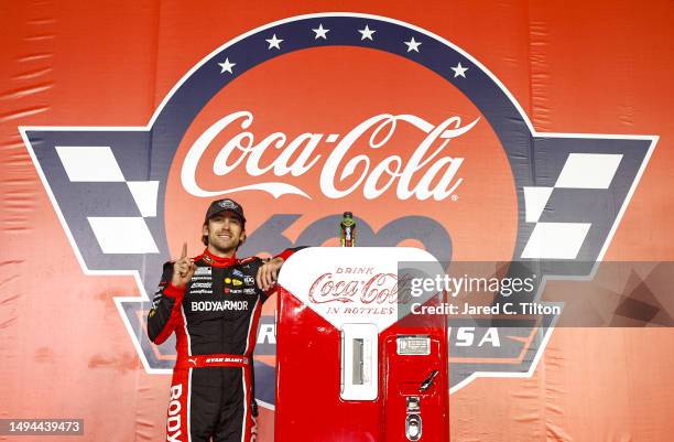 Ryan Blaney, driver of the BodyArmor Cherry Lime Ford, celebrates in victory lane after winning the NASCAR Cup Series Coca-Cola 600 at Charlotte...