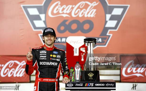 Ryan Blaney, driver of the BodyArmor Cherry Lime Ford, celebrates in victory lane after winning the NASCAR Cup Series Coca-Cola 600 at Charlotte...