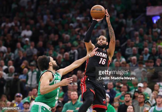 Caleb Martin of the Miami Heat attempts a three point basket against Derrick White of the Boston Celtics during the third quarter in game seven of...