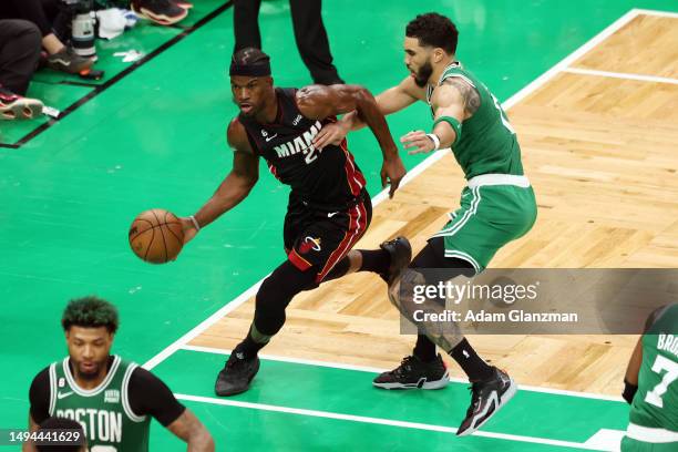 Jimmy Butler of the Miami Heat dribbles against Jayson Tatum of the Boston Celtics during the third quarter in game seven of the Eastern Conference...