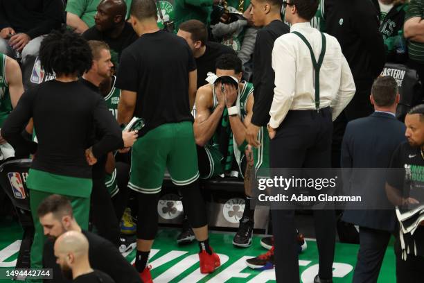 Jayson Tatum of the Boston Celtics reacts on the bench during the fourth quarter against the Miami Heat in game seven of the Eastern Conference...