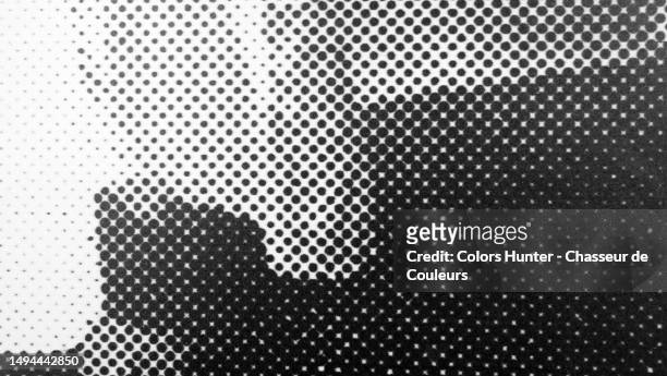 macro photograph of grey and black dots printed on a white poster pasted on a wall in paris, france - newspaper stock pictures, royalty-free photos & images