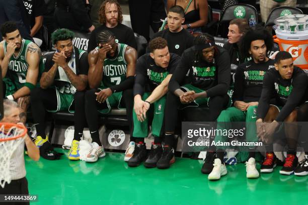 Boston Celtics players react on the bench during the fourth quarter against the Miami Heat in game seven of the Eastern Conference Finals at TD...