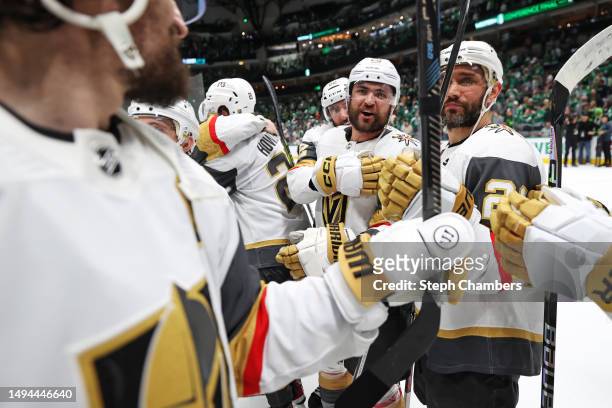 William Carrier of the Vegas Golden Knights and Brett Howden of the Vegas Golden Knights celebrates with Mark Stone of the Vegas Golden Knights after...