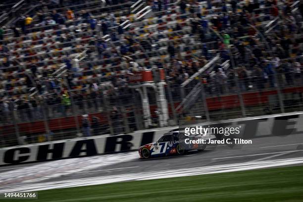 Justin Allgaier, driver of the Unilever Military DeCA RCPT Chevrolet, crosses the finish line to win the NASCAR Xfinity Series Alsco Uniforms 300 at...