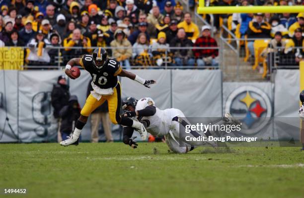 Kordell Stewart of the Pittsburgh Steelers narrowly escapes the defense of Sam Adams of the Baltimore Ravens during the AFC divisional playoff game...