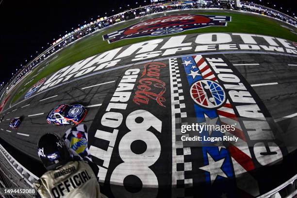 Justin Allgaier, driver of the Unilever Military DeCA RCPT Chevrolet, takes the checkered flag to win the NASCAR Xfinity Series Alsco Uniforms 300 at...