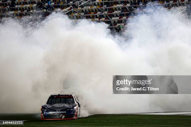 Justin Allgaier, driver of the Unilever Military DeCA RCPT Chevrolet, celebrates with a burnout after winning the NASCAR Xfinity Series Alsco...