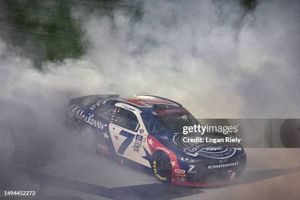 Justin Allgaier, driver of the Unilever Military DeCA RCPT Chevrolet, celebrates with a burnout after winning the NASCAR Xfinity Series Alsco...