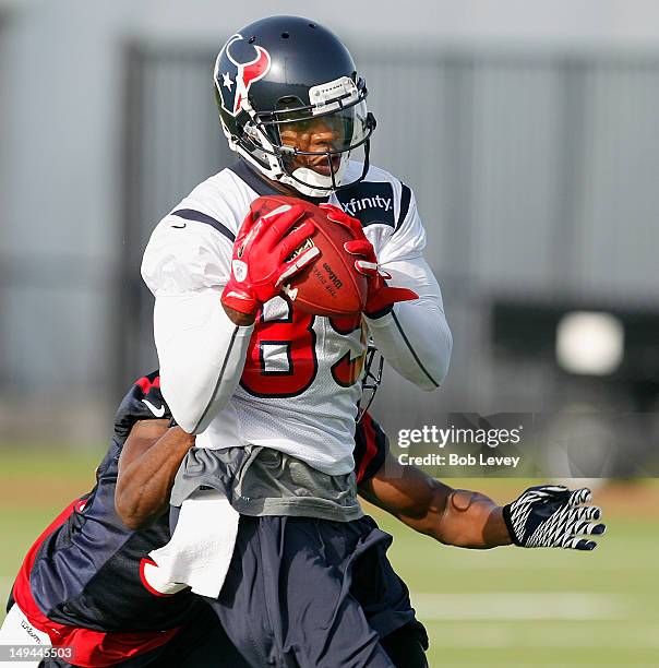 Wide receiver Bryant Johnson of the Houston Texans completes a pass during training camp at Reliant Park on July 28, 2012 in Houston, Texas.