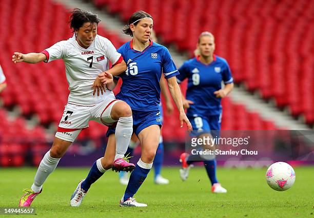 Re Yi Gyong of DPR Korea challenges Elise Bussaglia of France during the Women's Football first round Group G match between France and DPR Korea on...