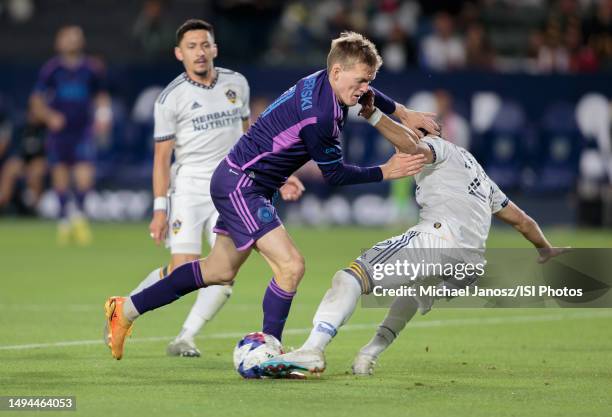 Karol Swiderski of Charlotte FC battles past Martin Caceres of the LA Galaxy moving with the ball during a regular season game between Charlotte FC...