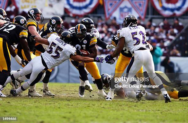 Amos Zereoue of the Pittsburgh Steelers runs against Jamie Sharper of the Baltimore Ravens during the AFC divisional playoff game at Heinz Field in...