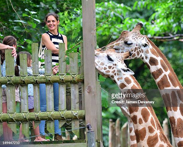 Katie Holmes and Suri Cruise feed giraffes at the Bronx Zoo on July 28, 2012 in New York City.
