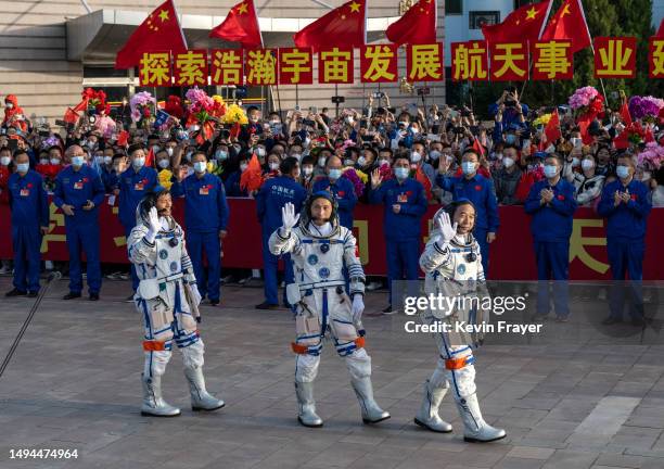 Chinese astronauts and crew of the Shenzhou-16 Gui Haichao, Zhu Yangzhu and mission leader Jing Haipeng from China's Manned Space Agency wave to...