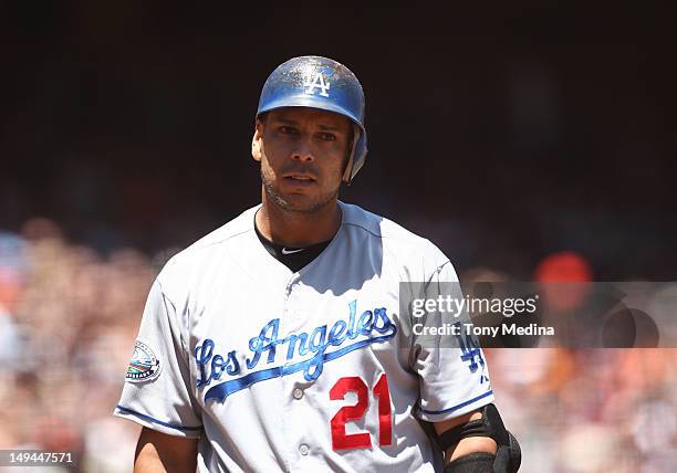 Dejected Juan Rivera of the Los Angeles Dodgers walks back to the dugout after striking out in the top of the fourth inning as the Los Angeles...