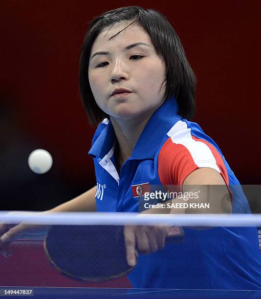 North Korea's Kim Jong returns a shot to Croatia's Cornelia Molnar during a table tennis women's singles preliminary round match of the London 2012...