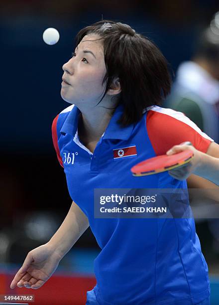 North Korea's Kim Jong serves to Croatia's Cornelia Molnar during a table tennis women's singles preliminary round match of the London 2012 Olympic...